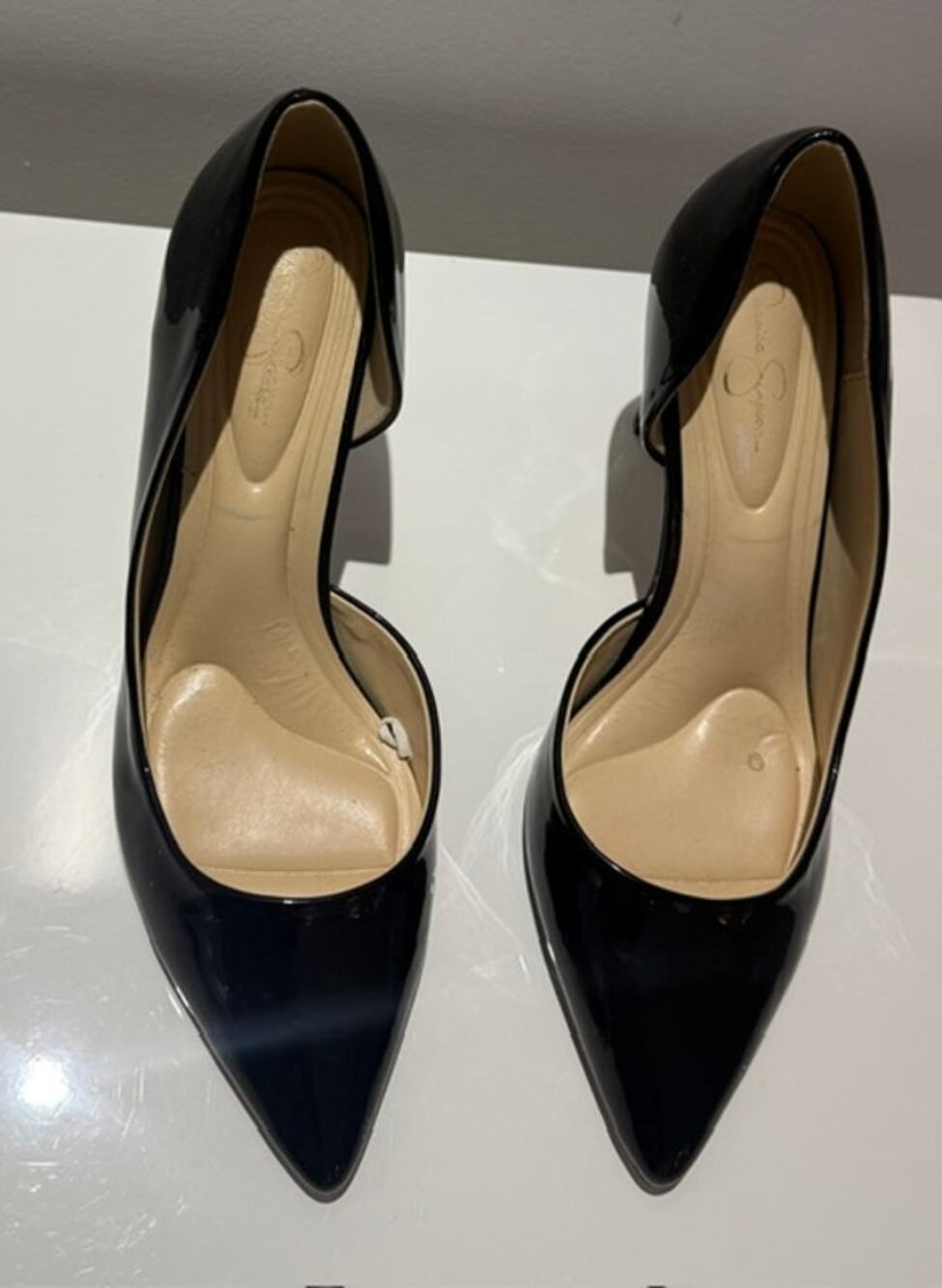 Black patent finish pumps by Jessica Simpson.